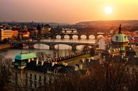 Panoramic view on Charles bridge and sunset Prague lights. Bohemia, Czech Republic